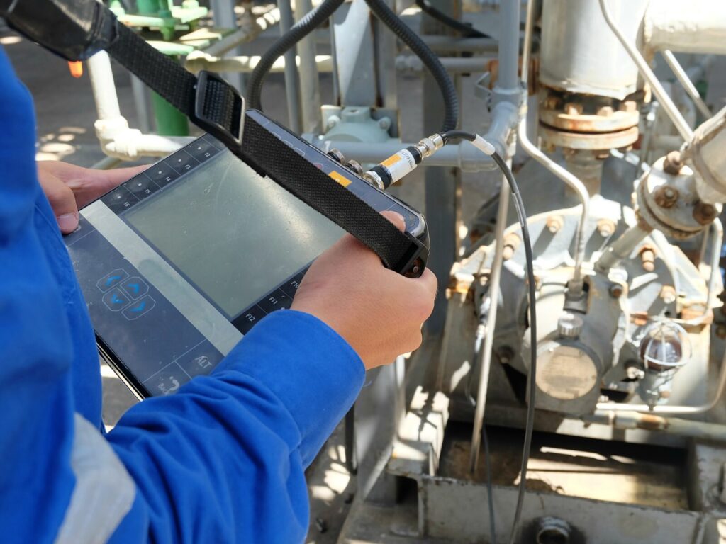Technician performs vibration analysis on a motor at an oil pipeline