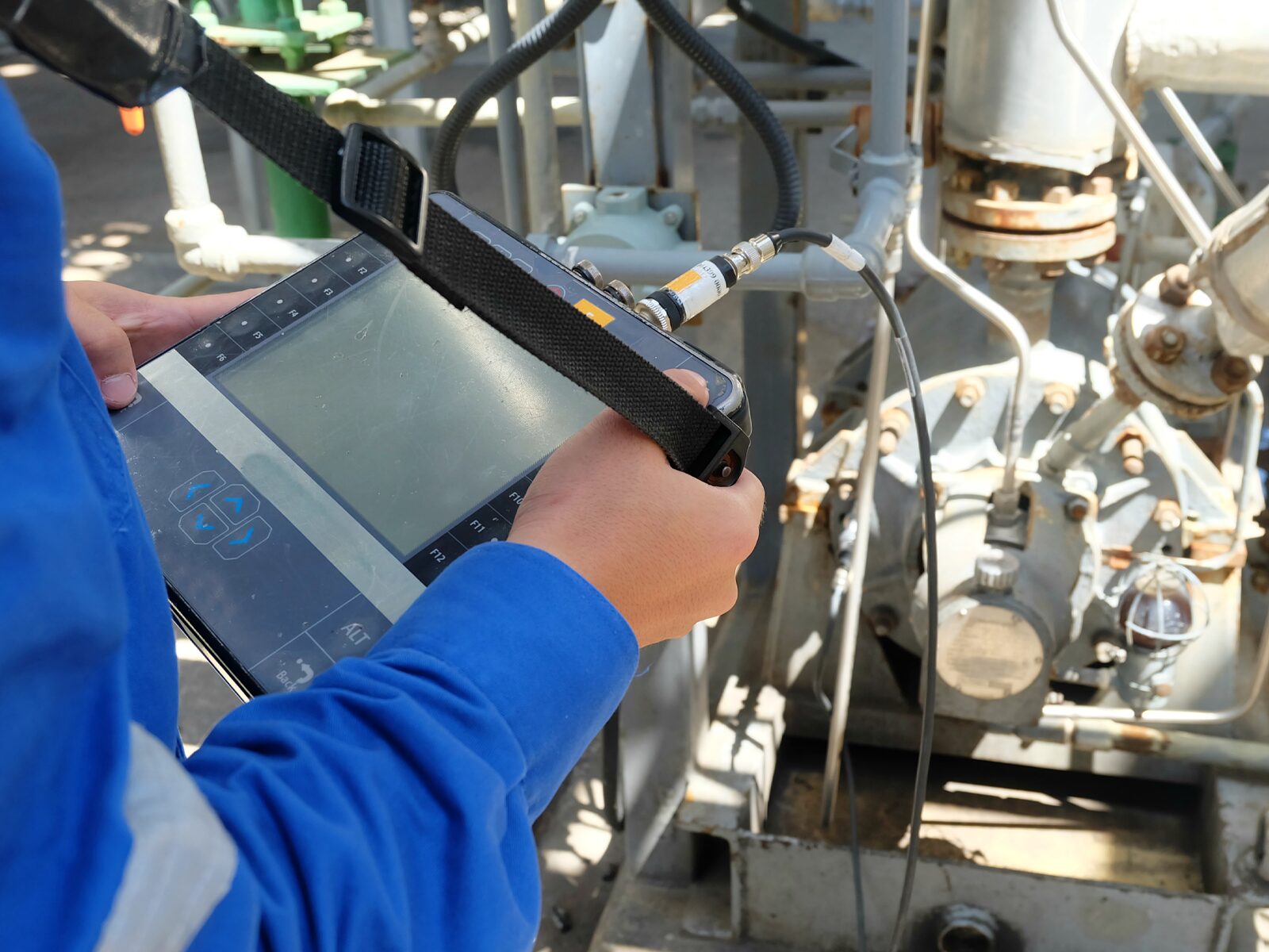 Technician performs vibration analysis on a motor at an oil pipeline