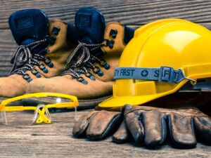 Workplace safety gear: non-slip boots, goggles, a hard hat, and gloves