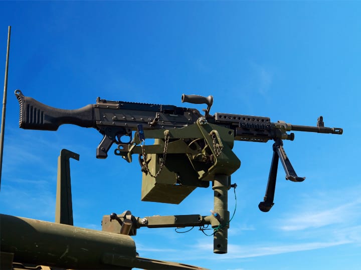 Mounted FN M240 Machine Gun Against Blue Sky