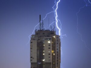 Lightning strikes the lightning protection system on a multi-story hotel.