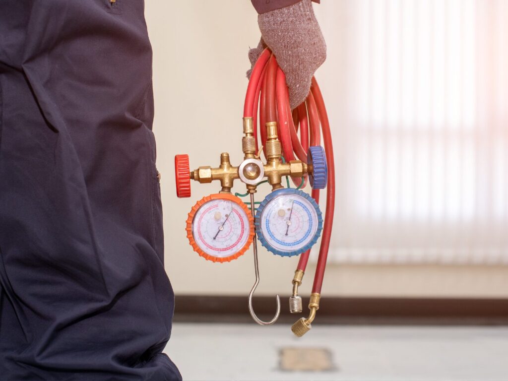 An air quality expert holds two circular gauges