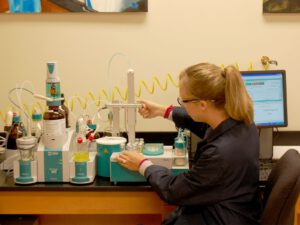 Chemist prepares a sample for Karl Fischer chemical analysis.