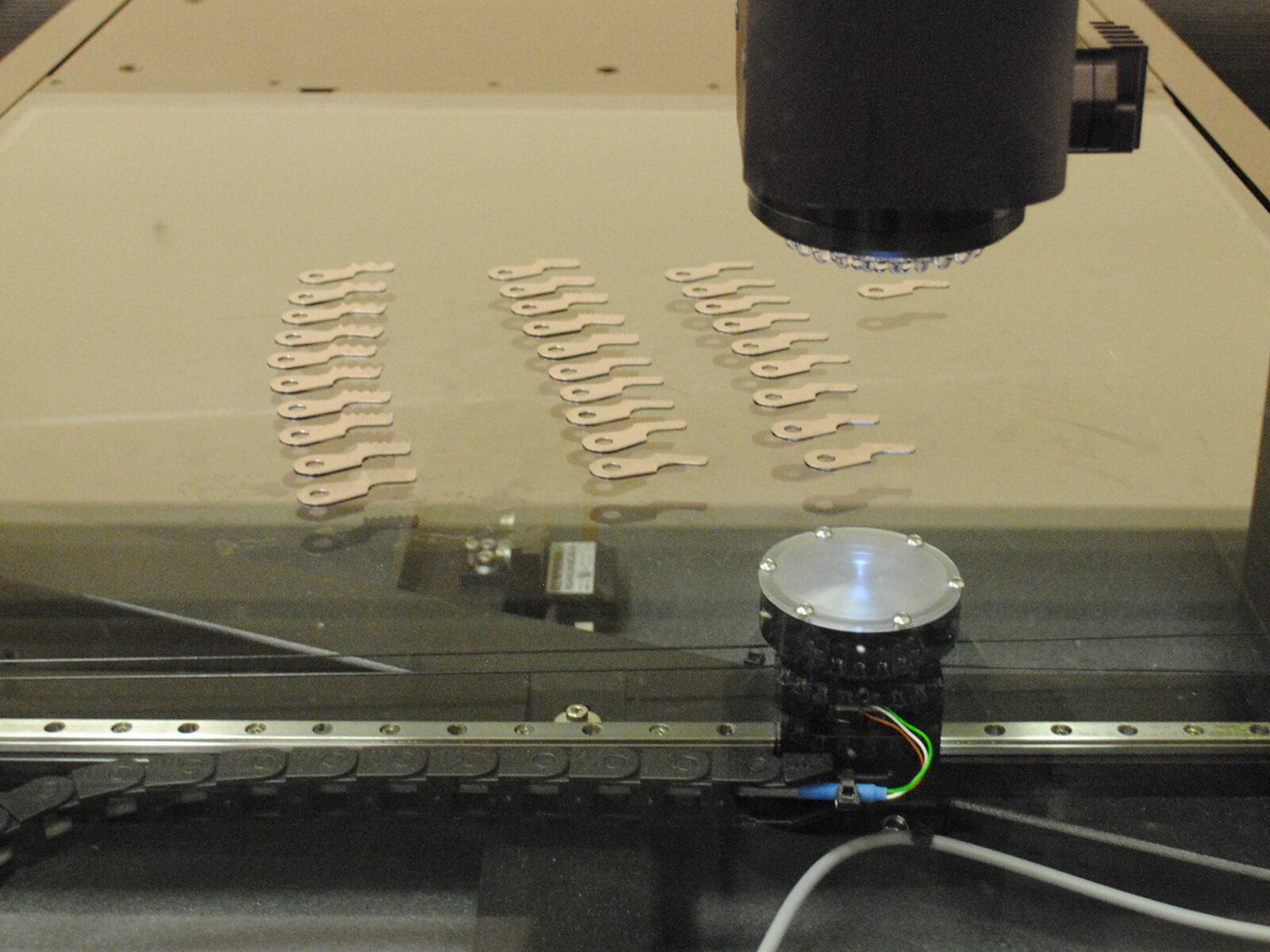 Focus on a dimensional measurement machine as it scans parts.