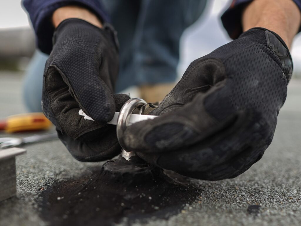 Focus on a technician tagging a roof anchor