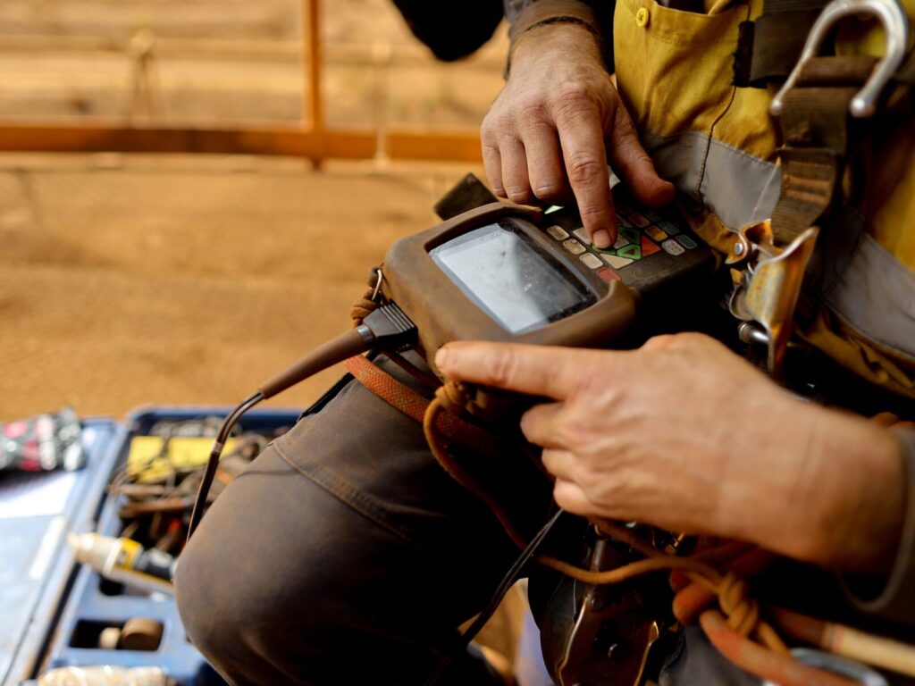 Rope access technician prepares an ultrasonic tester