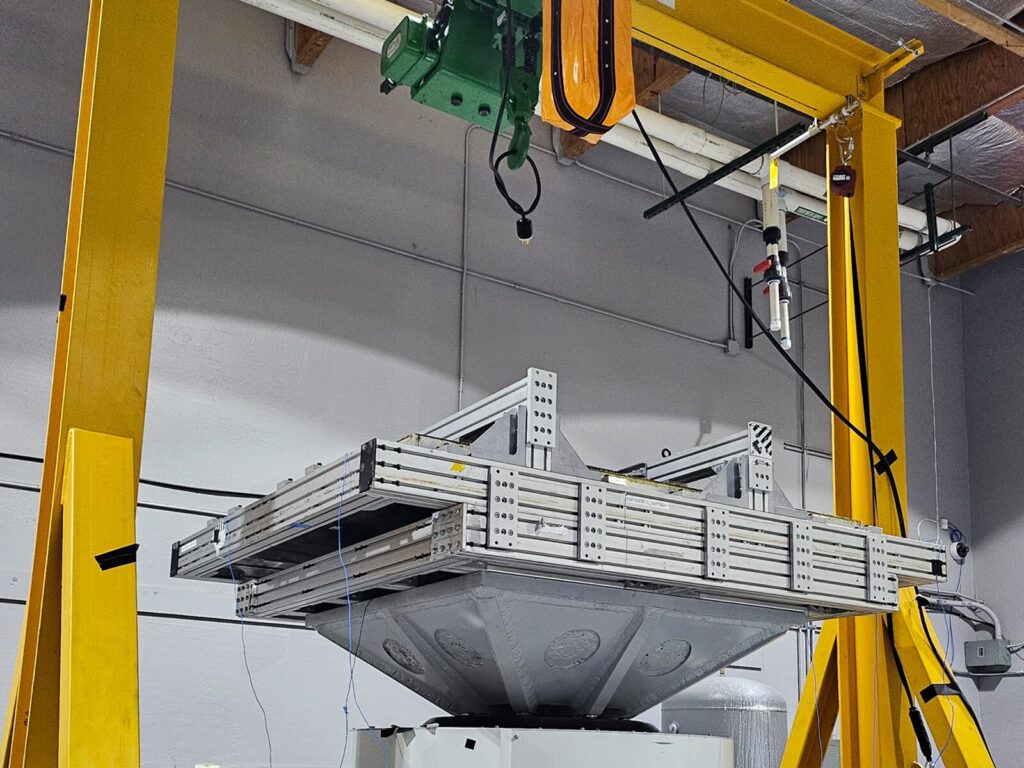Component lowered onto shaker frame and table