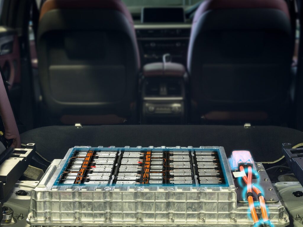 Electric vehicle during assembly. Exposed battery pack in the floor.