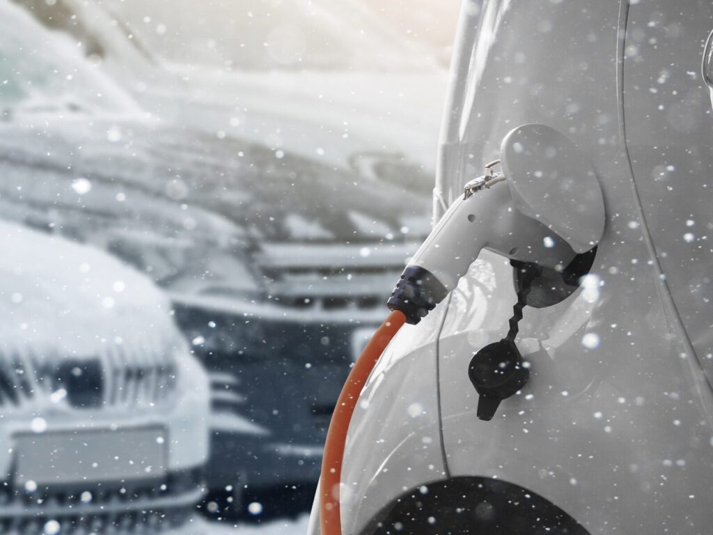 Focus on the charging port of an electric vehicle in the snow.