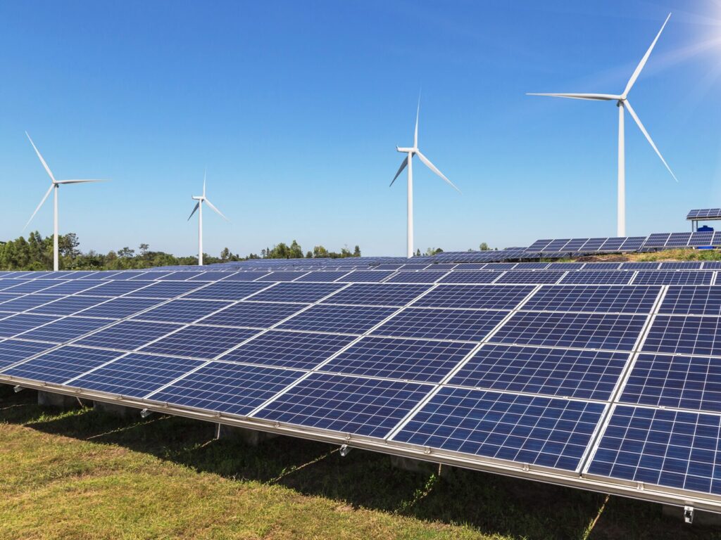 Rows of solar panels and wind turbines