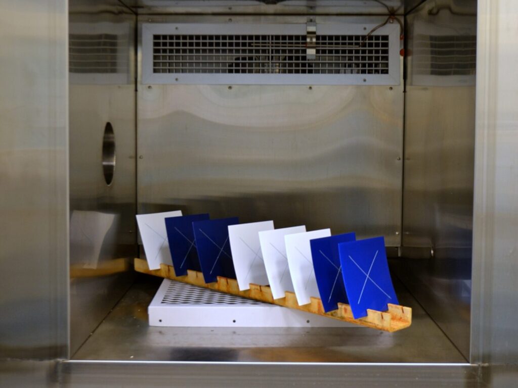 Blue and white material samples in a humidity cycling chamber