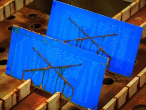 Rusted X's on salt fog corrosion testing samples