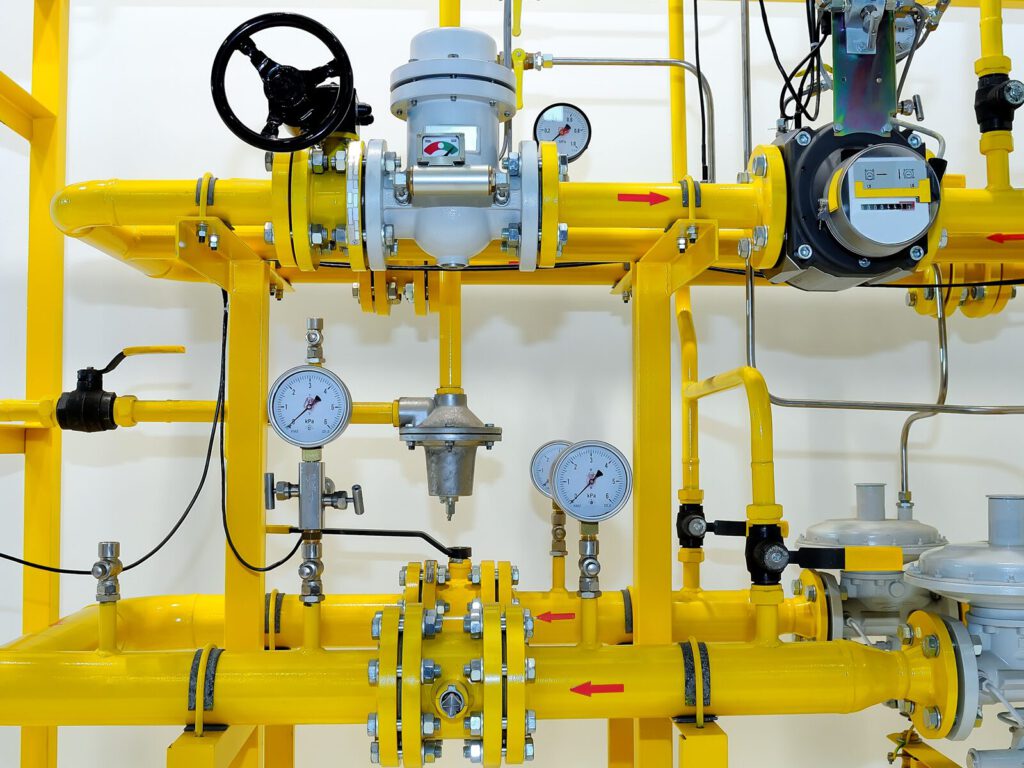 Yellow pipelines in an indoor facility. Gas flow meters.