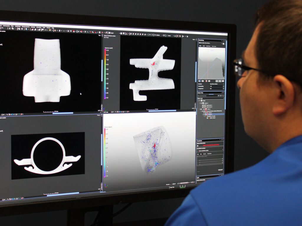 Technician studies 3D scans of components on a computer monitor