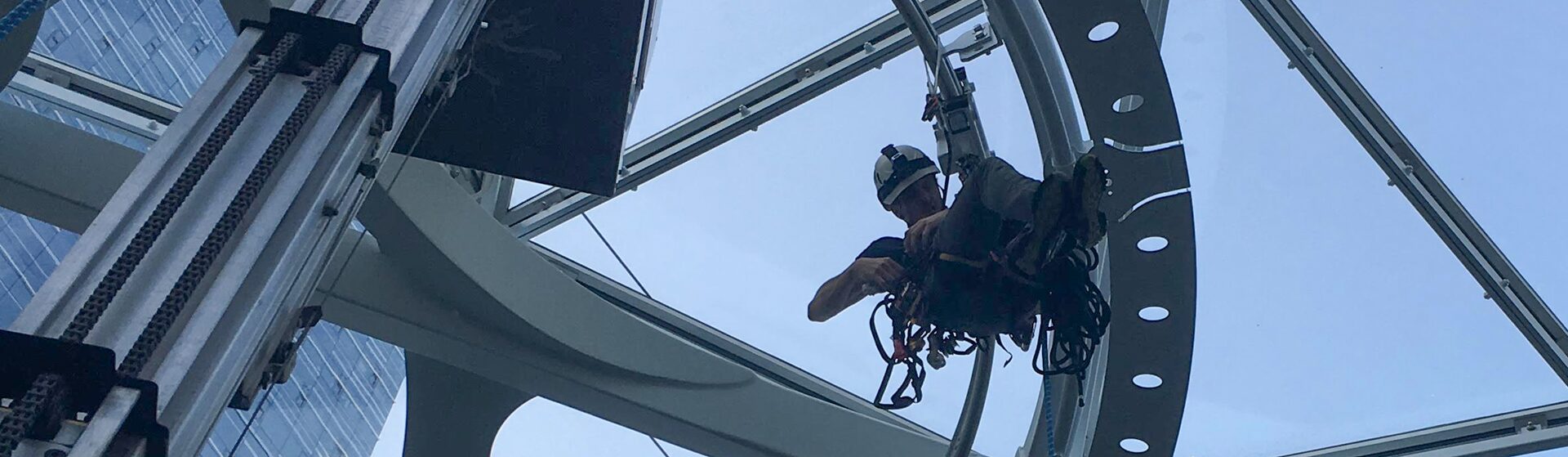 Rope access technician suspended in a spherical structure