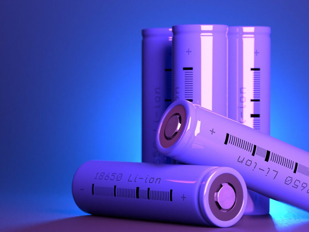 Five purple lithium ion batteries against a blue background. Three batteries are positioned upright. Two are horizontal.