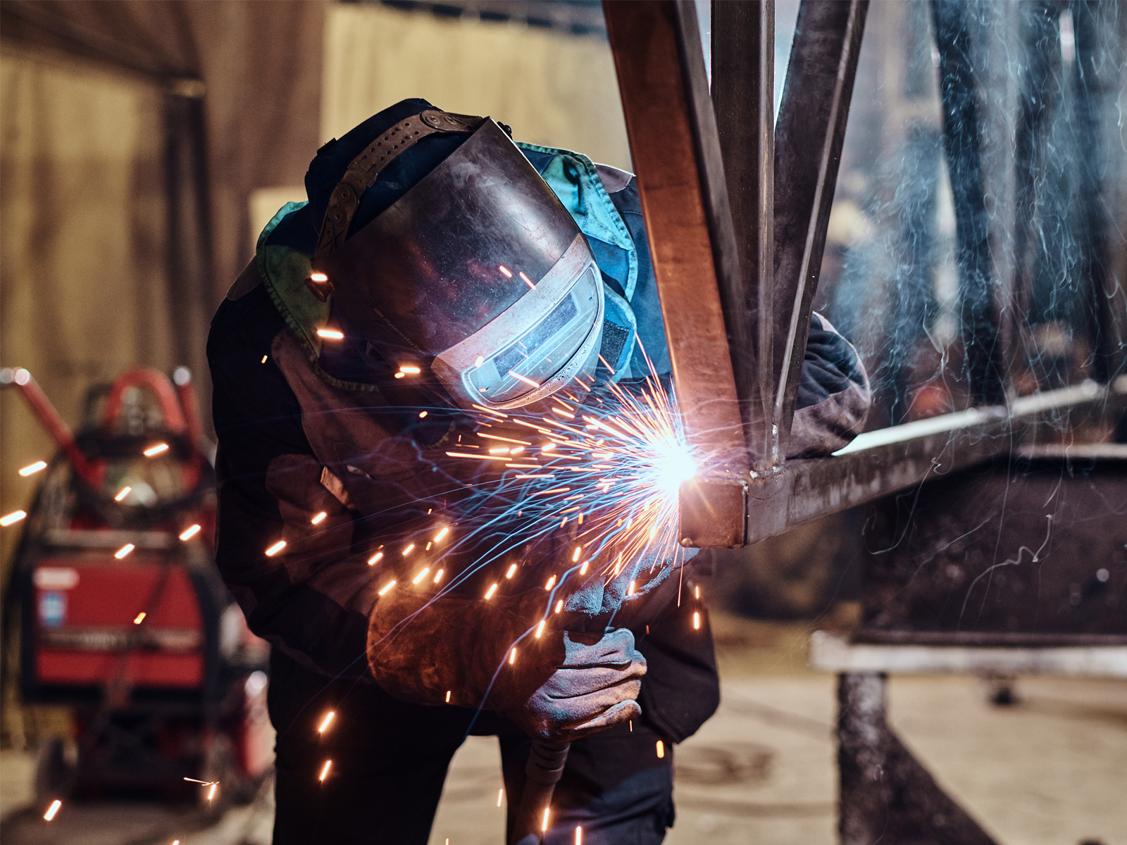 Professional welder lays a weld on a thermite rail for a bridge