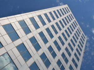 Tall office building pictured from the ground looking up
