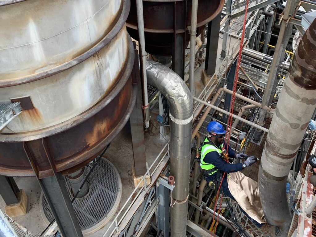 Rope access technician in an oil and gas facility