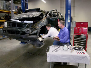 Two Forensic Investigators Analyzing Wrecked Car