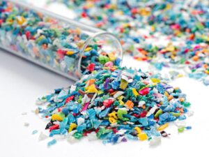 Multi-colored polystyrene samples spill out of a test tube