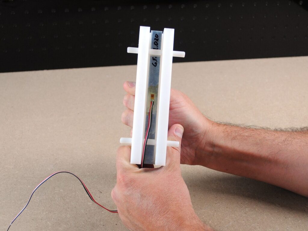 Expert holds a linear strain gauge