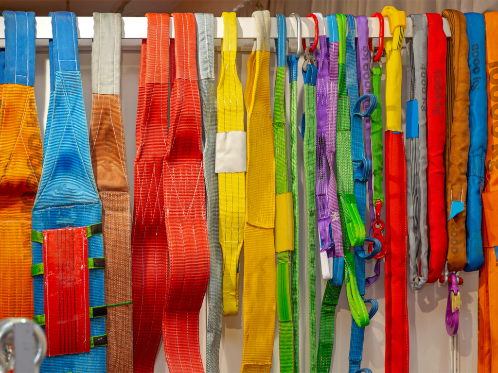 A series of lifting slings on a rack