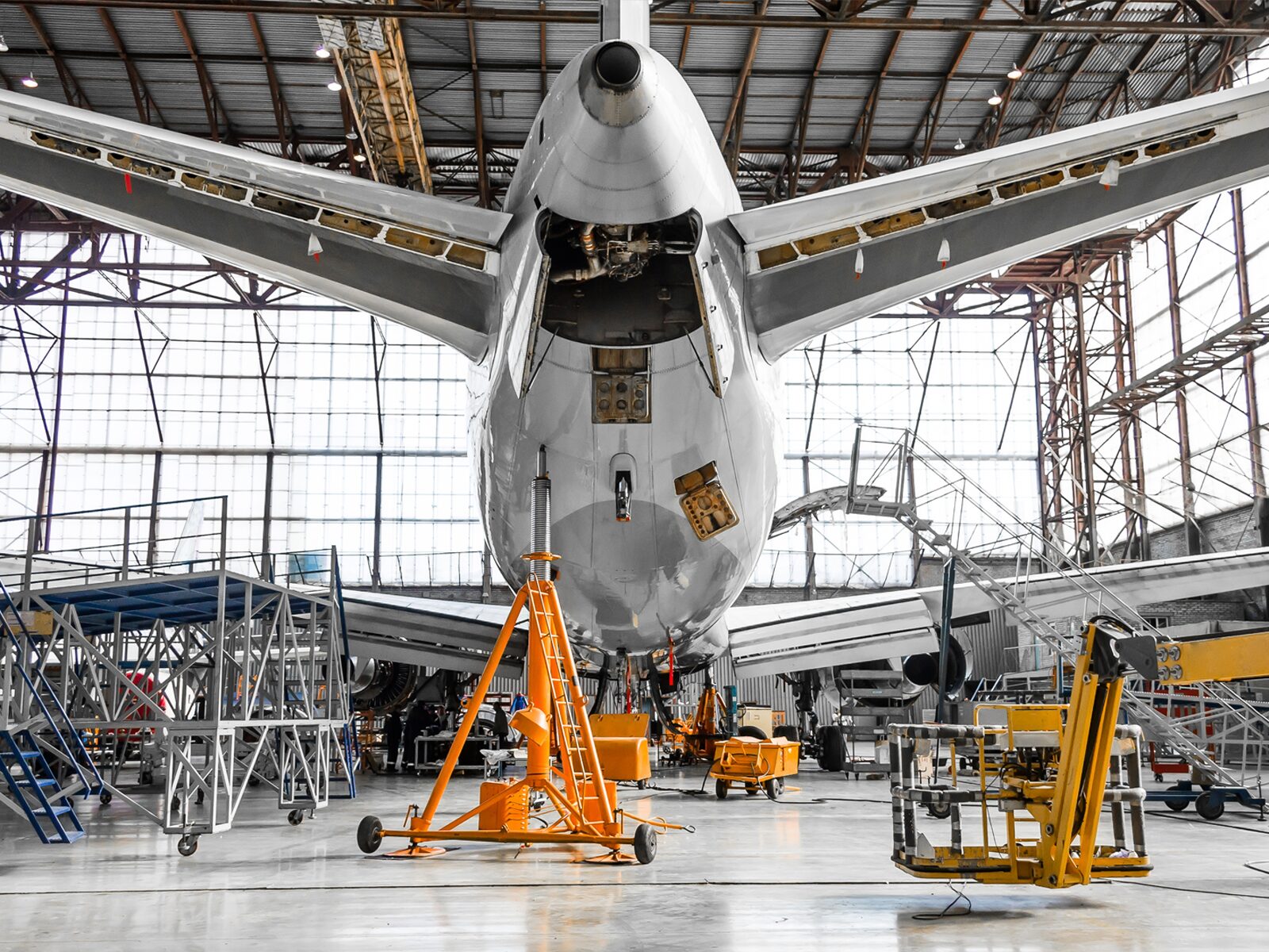 underside of a commercial plane in a hangar