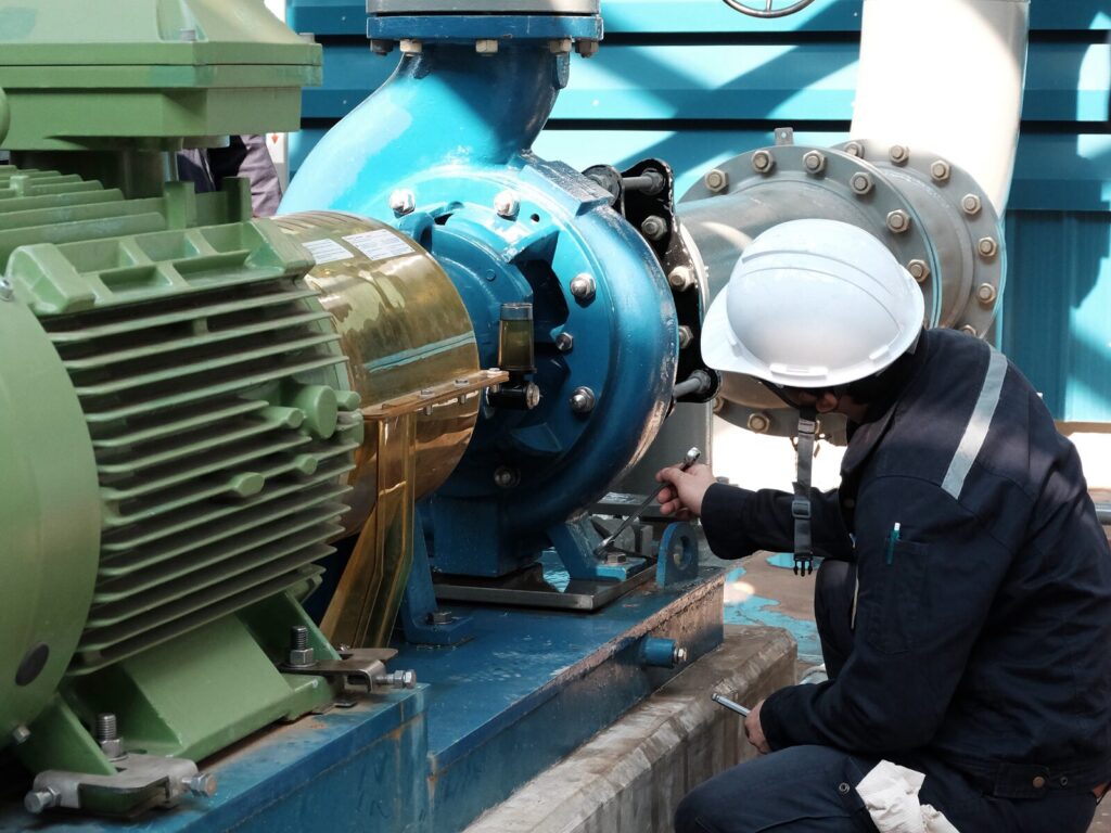 Engineer inspects an electric motor and water pump