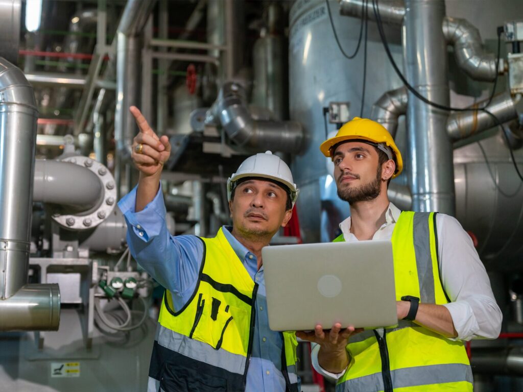 Two engineers at an oil and gas facility.