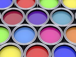 Rows of open paint cans of various colors