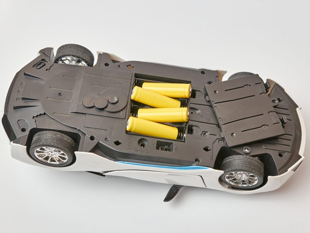 Underside of a toy car with the batteries exposed