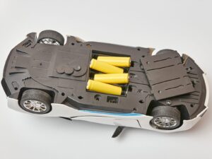Underside of a toy car with the batteries exposed