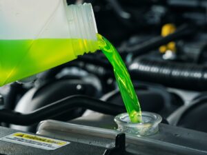 Green engine coolant pours into a radiator