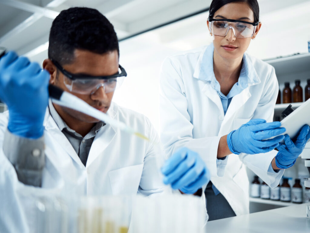 Two Scientists Administering a Sample for Analysis