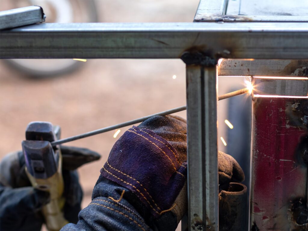 Close up on a welding stick and bar during welding