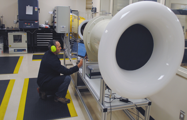 Technician Calibrating an Anemometer Using a Wind Tunnel