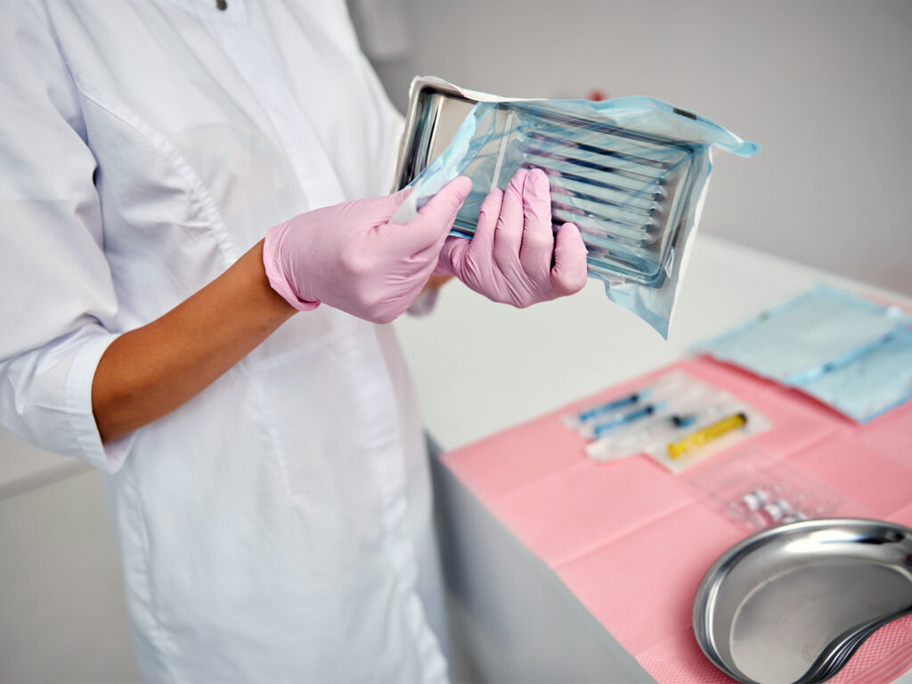 Medical Professional Opening Pack of Sealed Implements