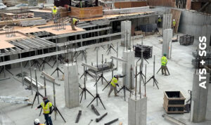 a group of men standing around a building under construction
